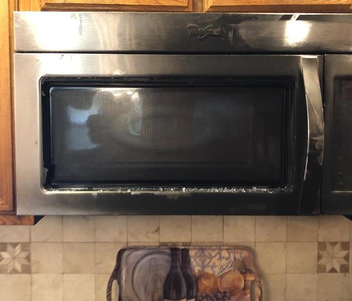 Microwave oven with smoke damage mounted over range