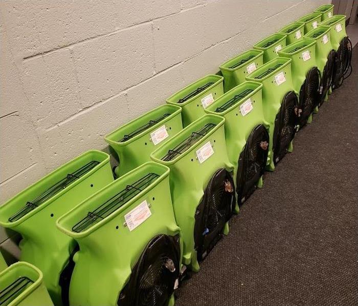 SERVPRO drying equipment lined along hallway of commercial building