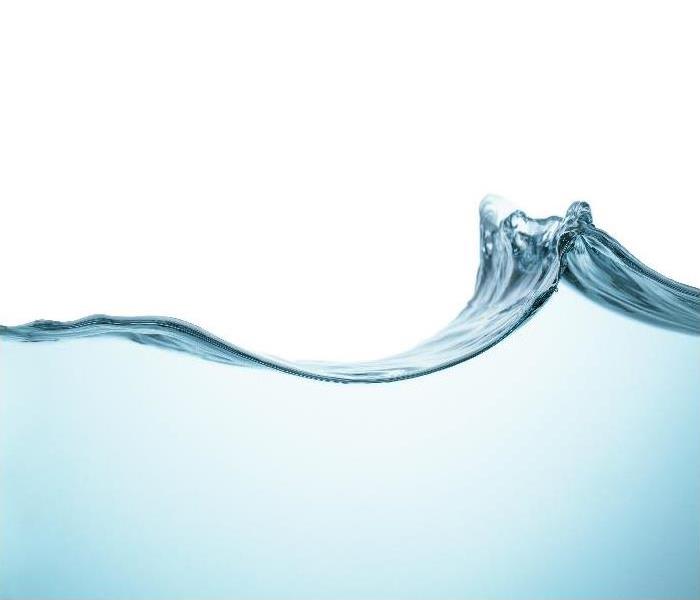 Clear, blue water wavy surface with splash