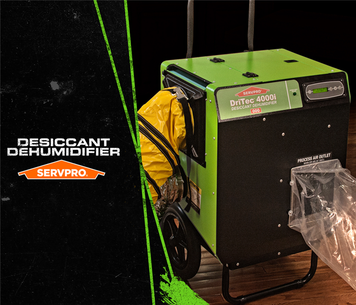 Green SERVPRO dehumidifier equipment with caption: DESICCANT DEHUMIDIFIER